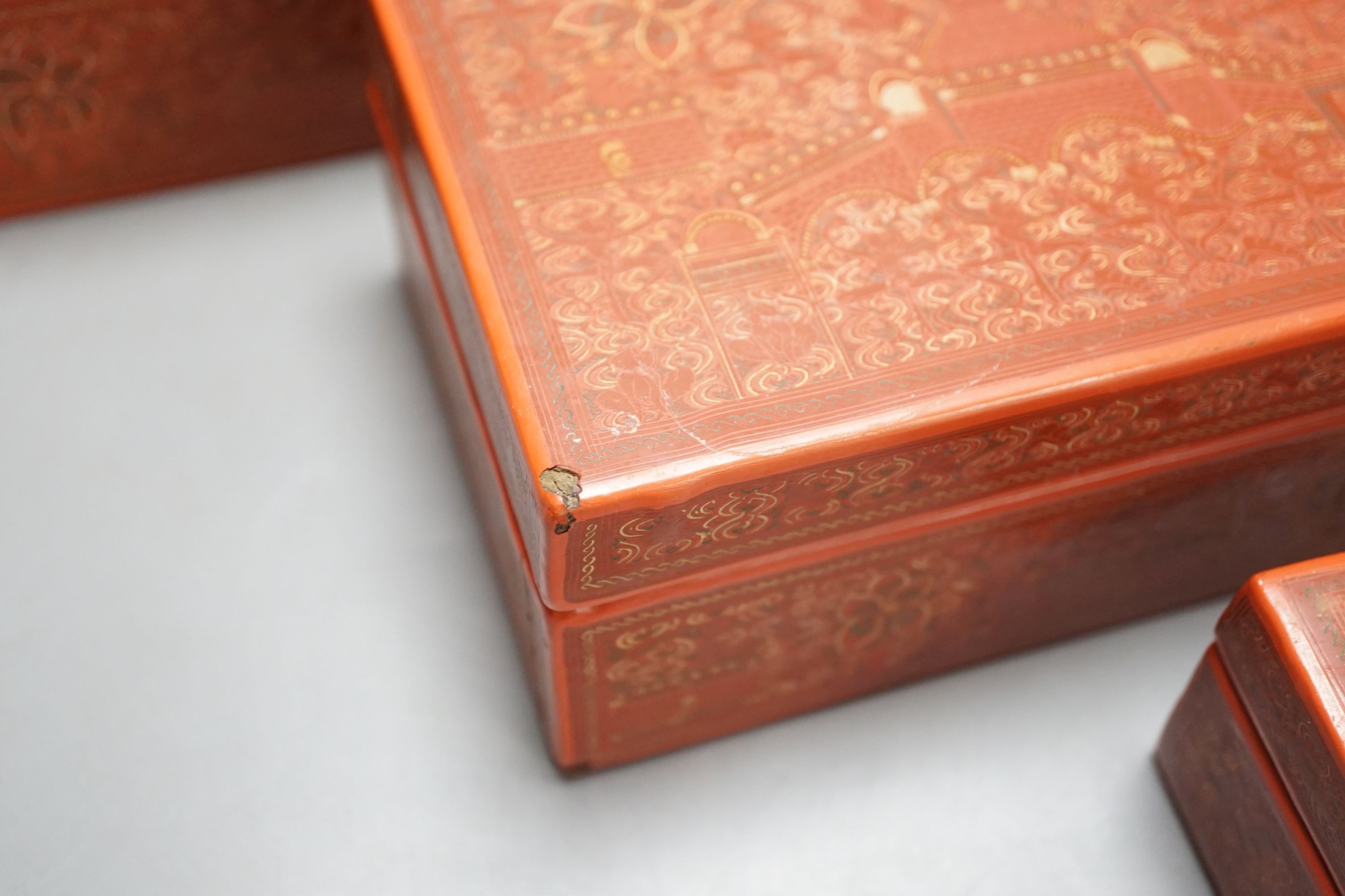 Three Burmese red lacquer graduated boxes, largest 21 cms wide.